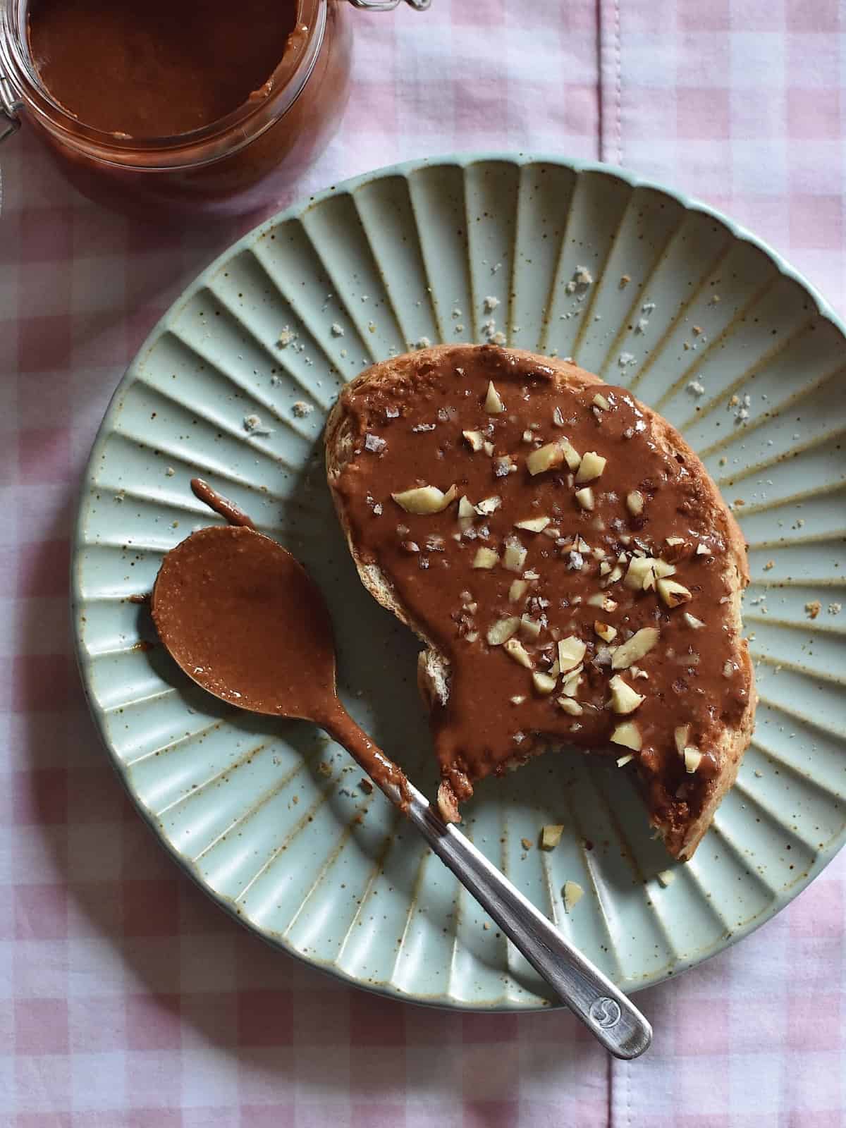 Gianduja on top of a sliced bread topped with crushed nuts.