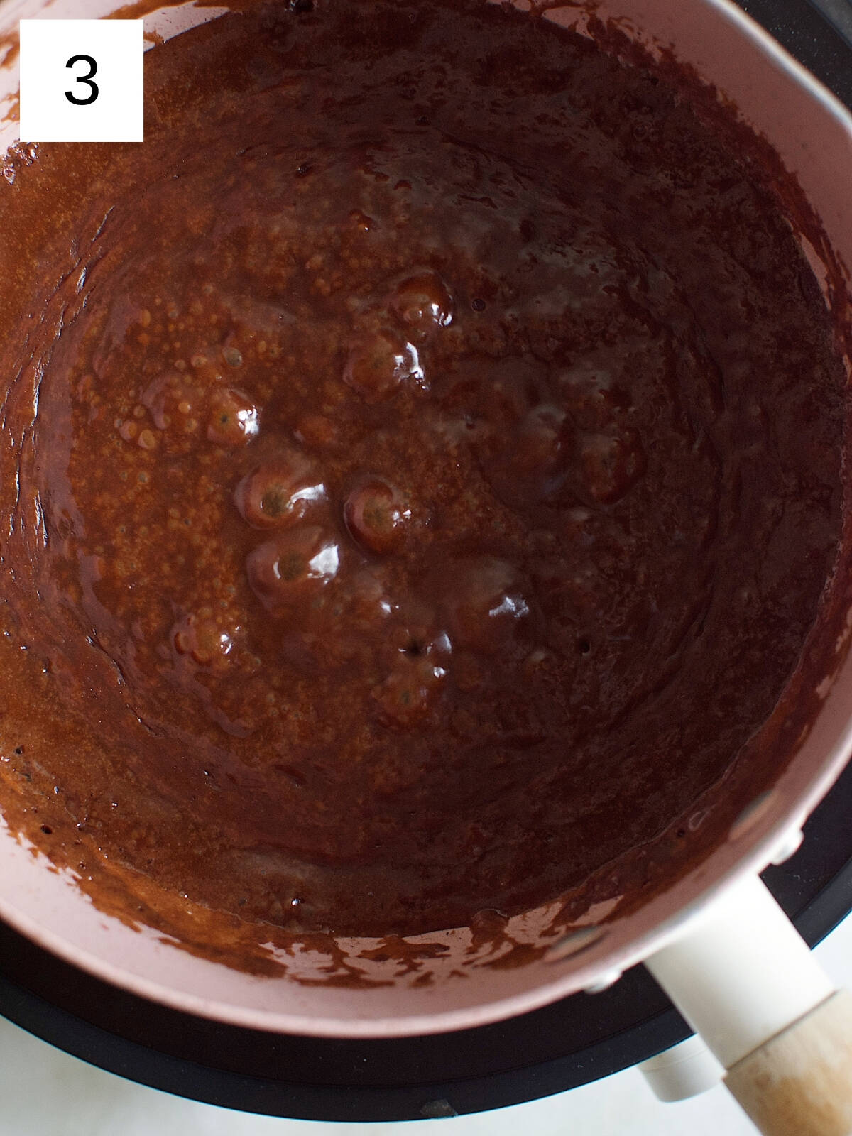 Boiled cocoa mixture in a heated nonstick pan.