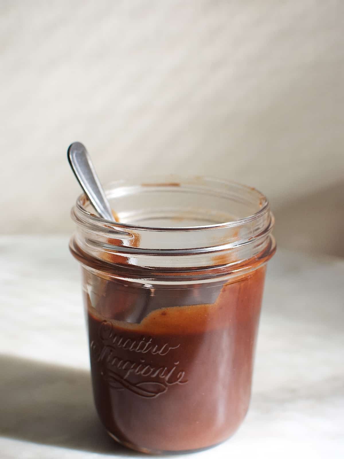 A glass jar of hot fudge.