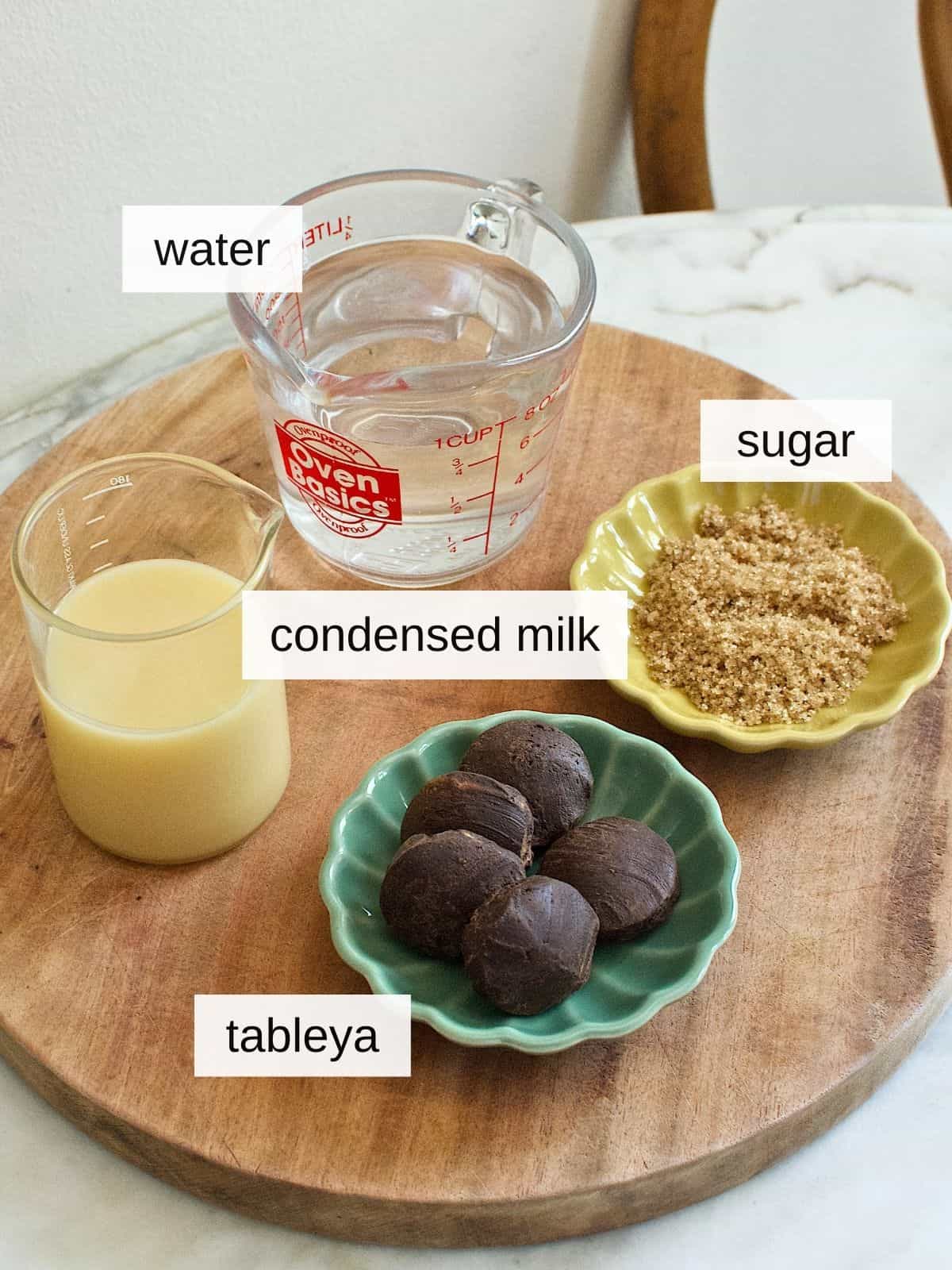 ingredients for sikwate recipe, including water, sugar, condensed milk, and tableya.