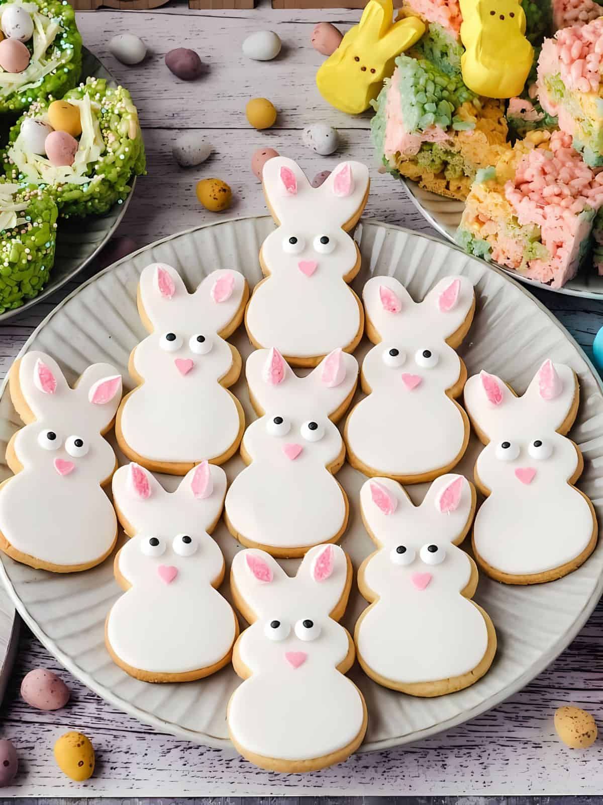 A bunch of bunny themed cookies on a plate.