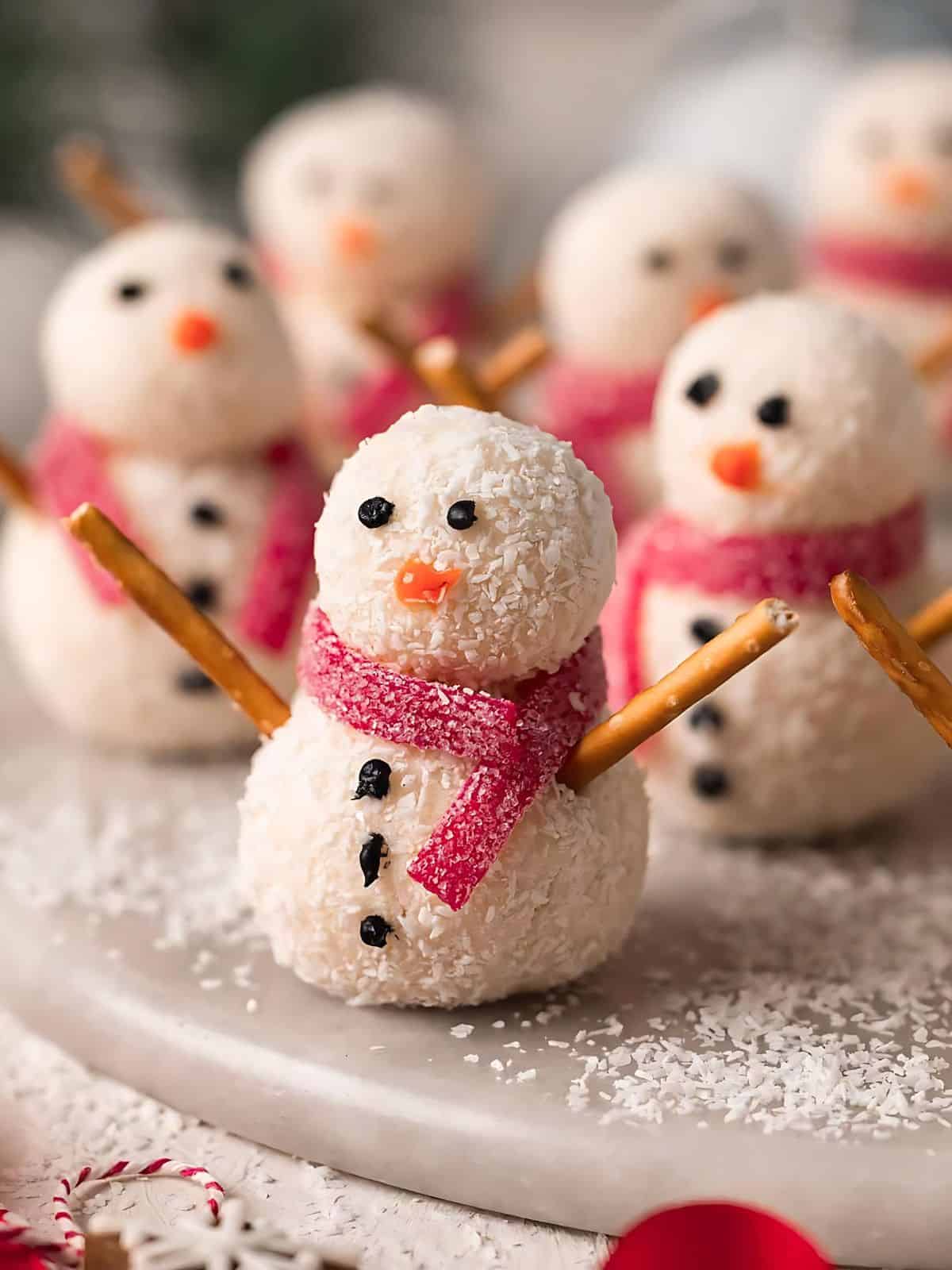 Snowman themed coconut truffles sprinkled with coconut shavings.