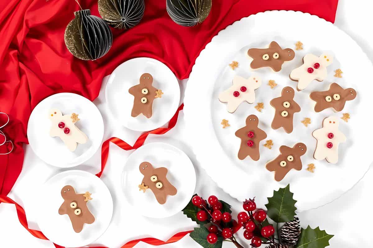 Gingerbread jello jigglers on a plate covered with cream and chocolate.