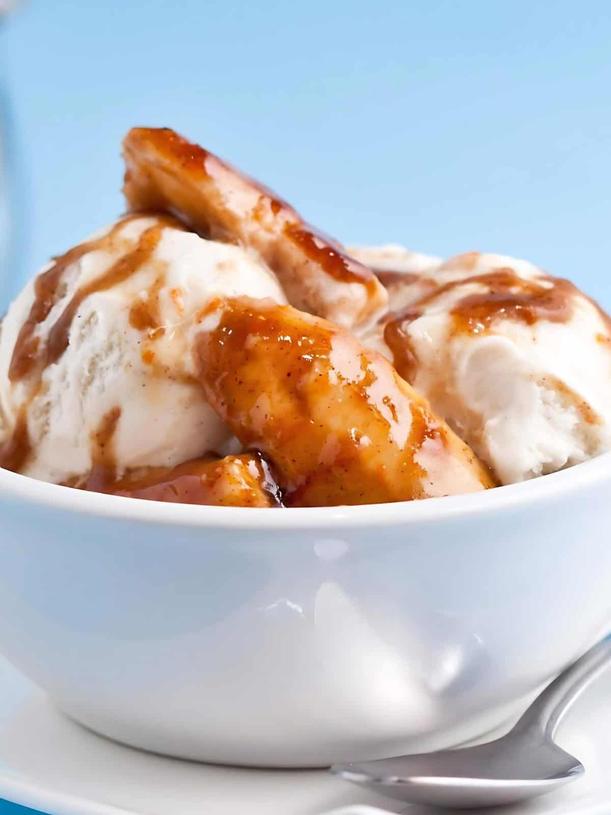 Banana foster in a bowl drizzled with caramel.