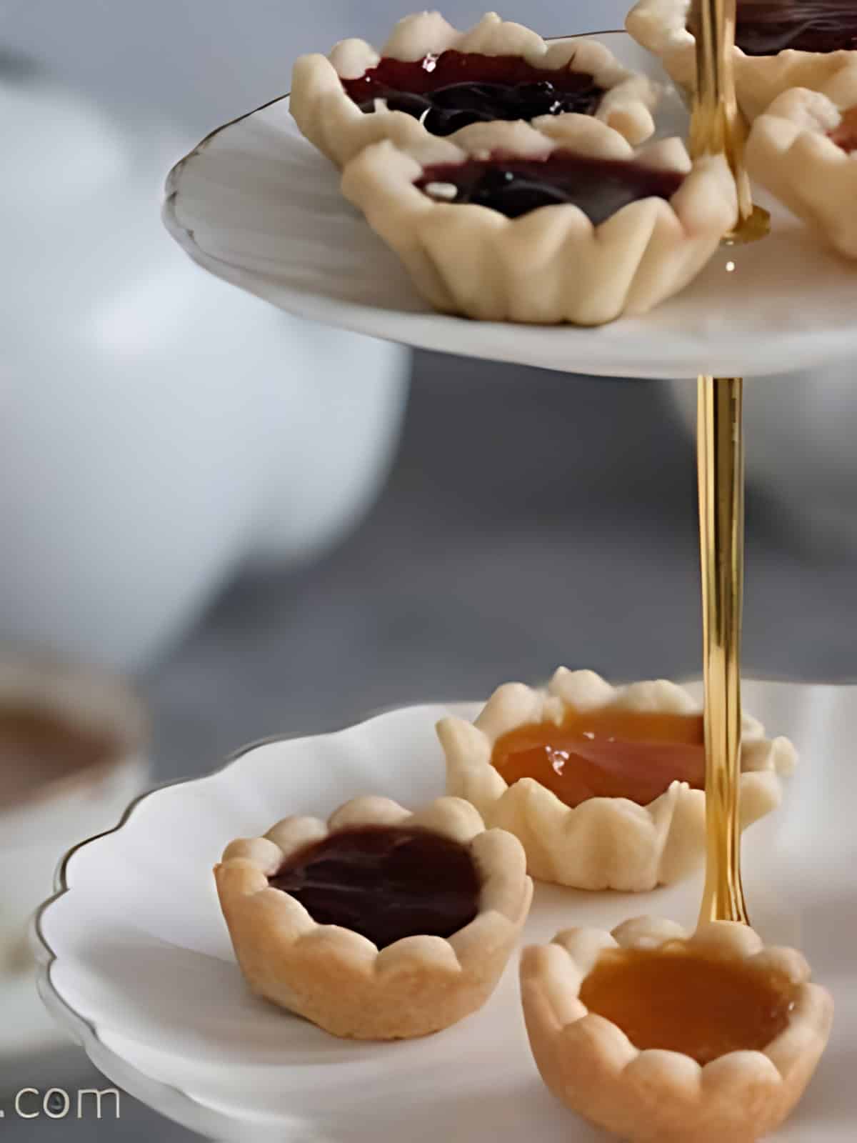 Different flavors of Jam tarts on a plate.