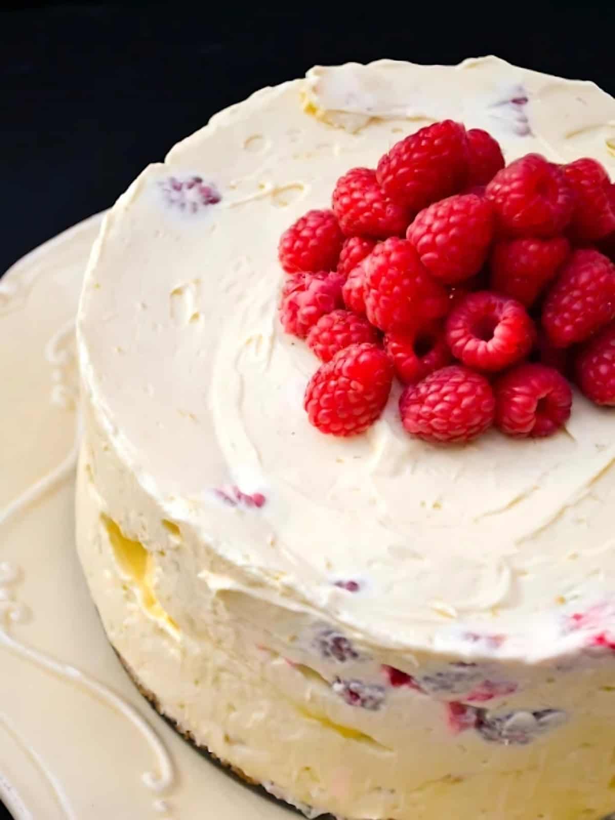 Lemon Curd Raspberry Cheesecake topped with raspberries.