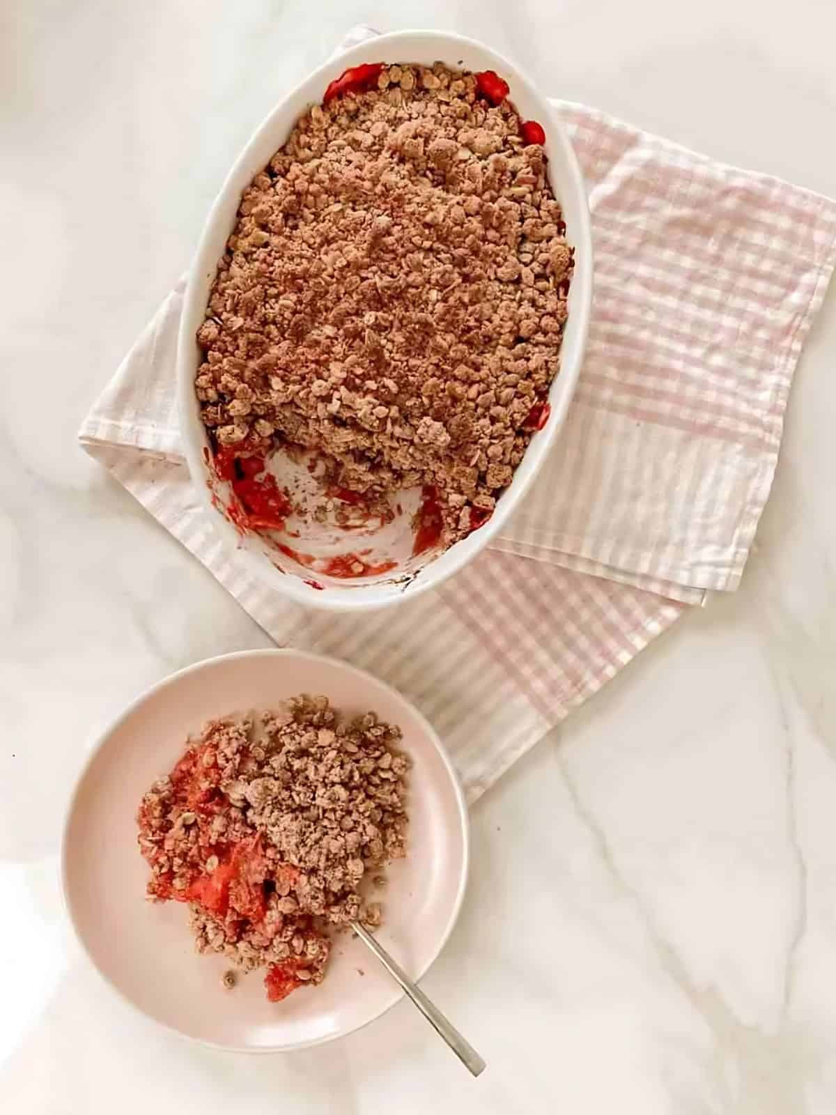 Rhubarb Crumble platter with a serving of crumble on a plate.