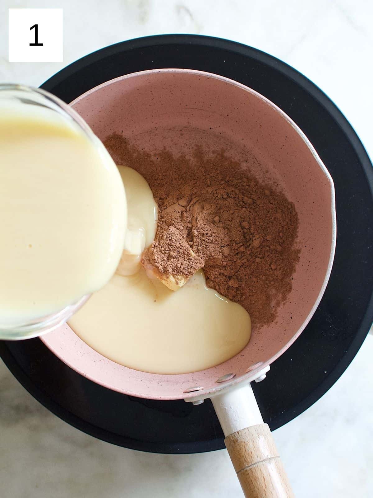 combining the butter, sweetened condensed milk, and cocoa powder in a saucepan.