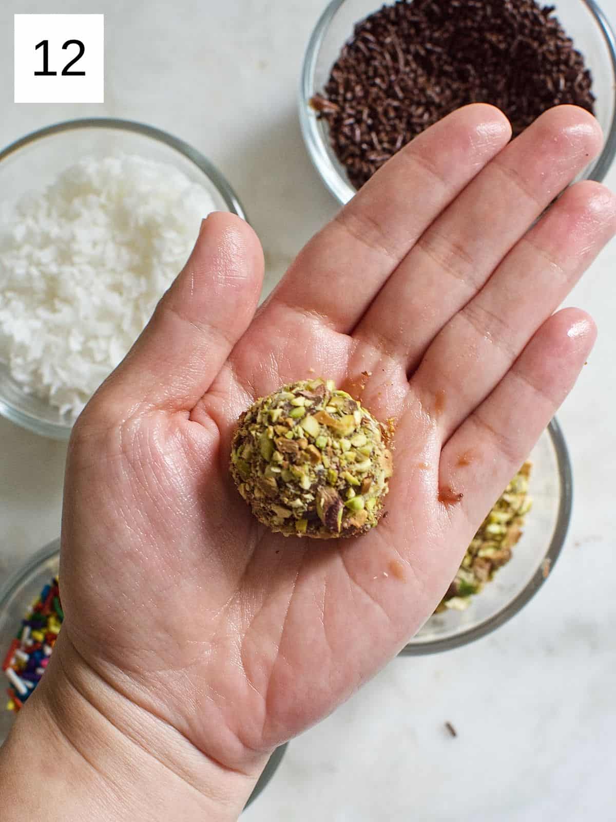 brigadeiro ball coated with chopped nuts.