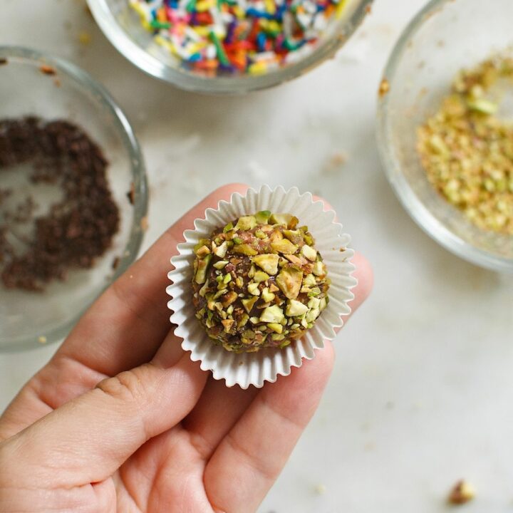 brigadeiro ball, coated with chopped nuts, in a mini cupcake liners.