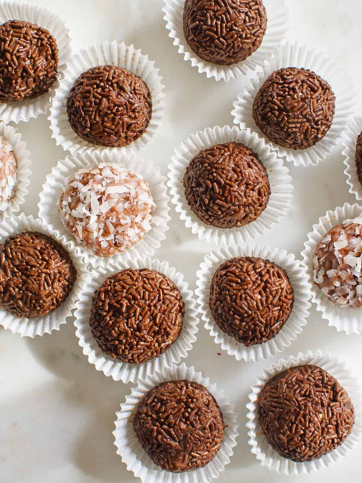 brigadeiro balls, coated with chocolate sprinkles and coconut flakes, in a mini cupcake liners.