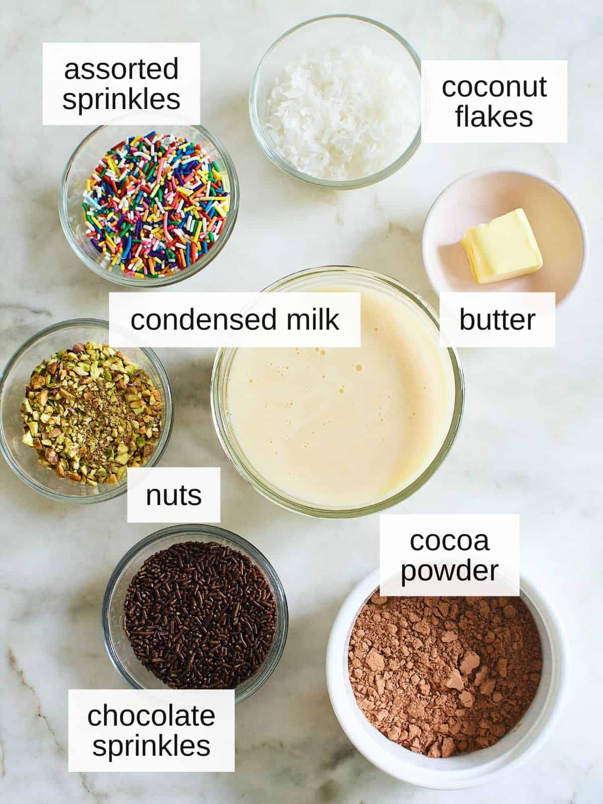 ingredients for brigadeiros, a Brazilian chocolate balls, including assorted sprinkled, coconut flakes, condensed milk, butter, nuts, cocoa powder, and chocolate sprinkles.