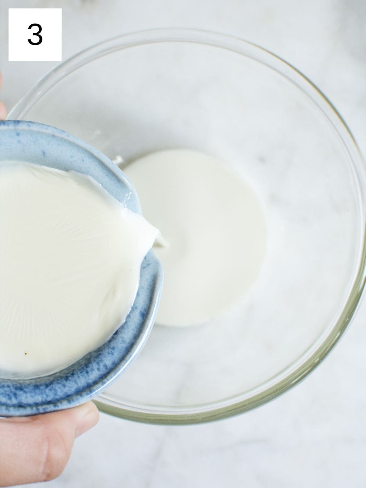 milk being poured into a mixing bowl.