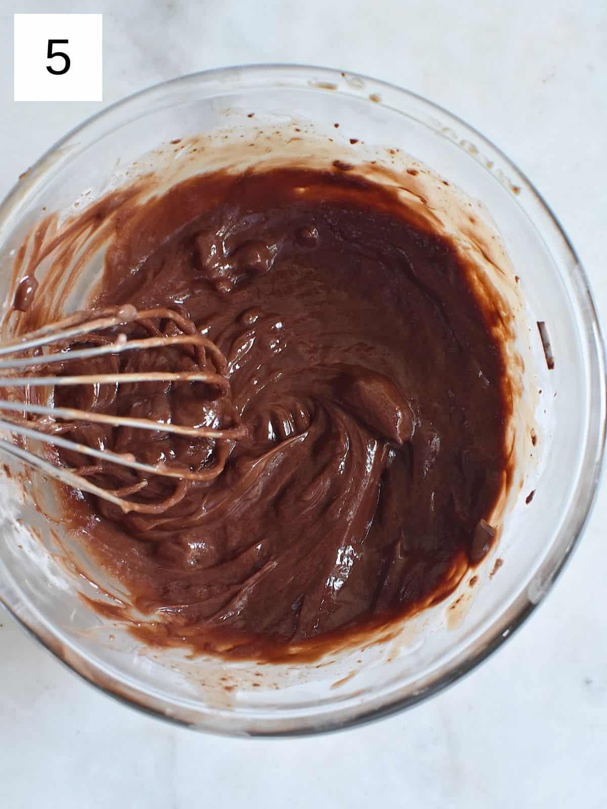 melted mixture of milk and chocolate in a mixing bowl.