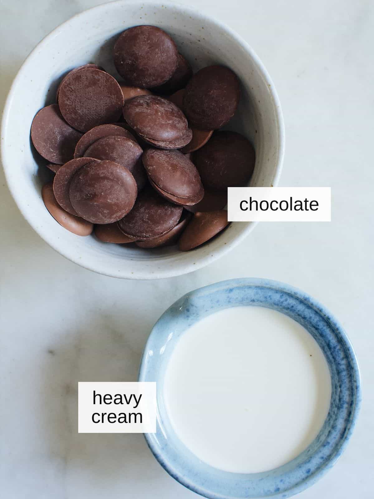 ingredients for chocolate dipping sauce, including chocolates and heavy cream.