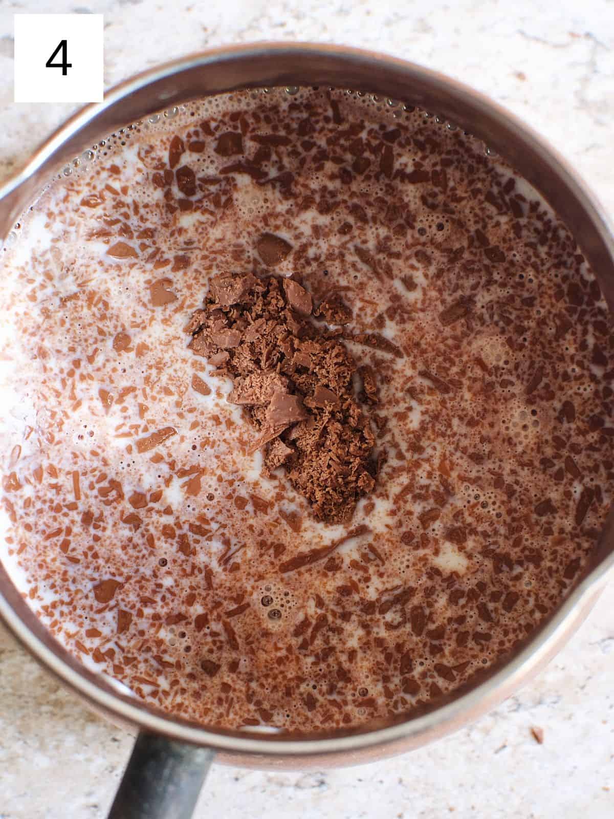 a pan filled with a mixture of chocolate and milk.