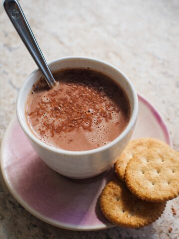 a mug of hot chocolate and some crackers.