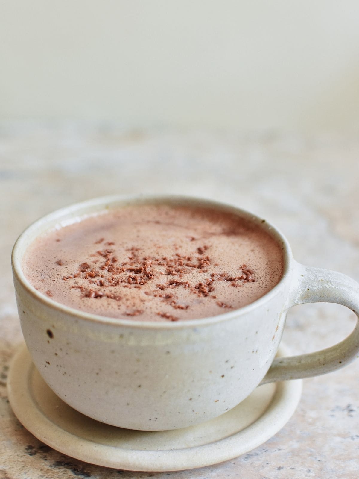 a cup of hot chocolate sitting on top of a saucer.