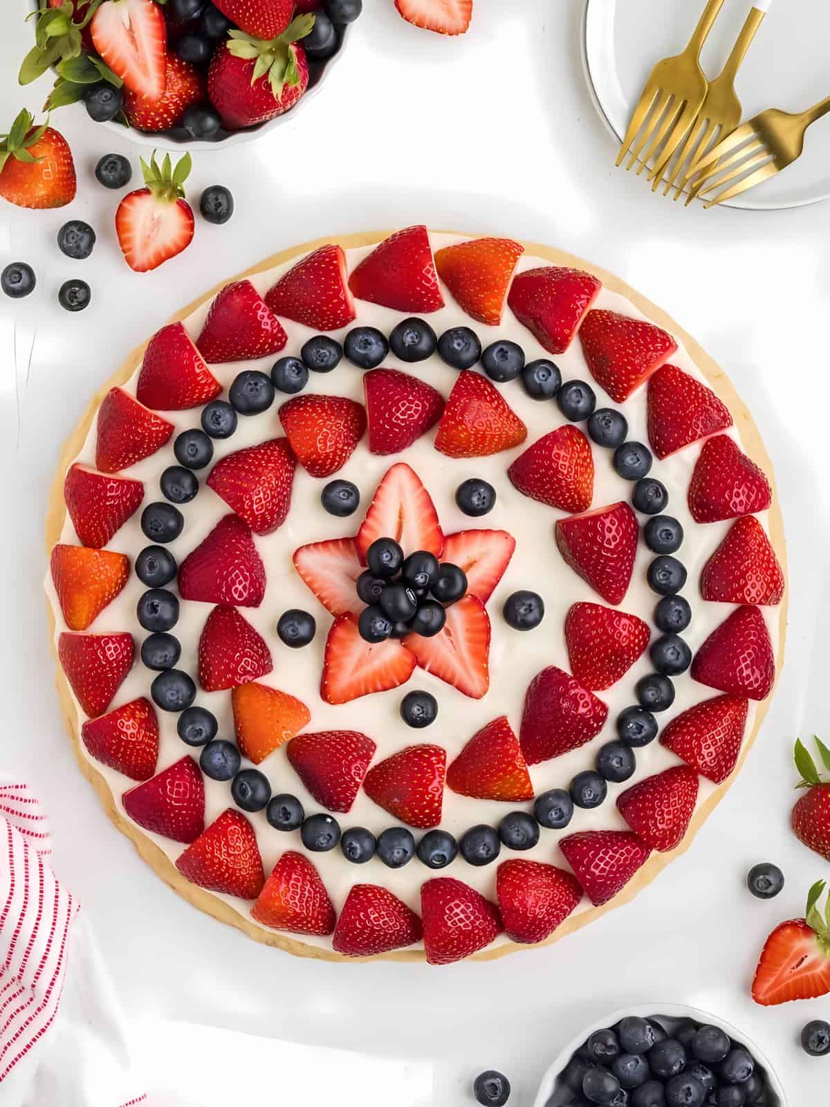 4th of July fruit pizza topped with blueberries and strawberries.