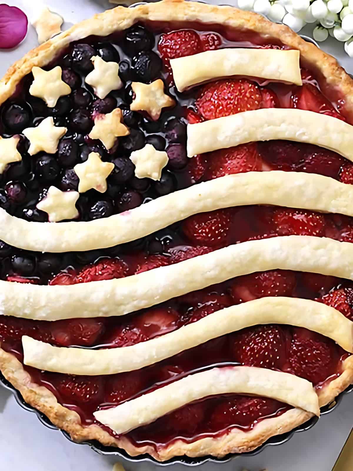 American flag themed pie topped with berries.