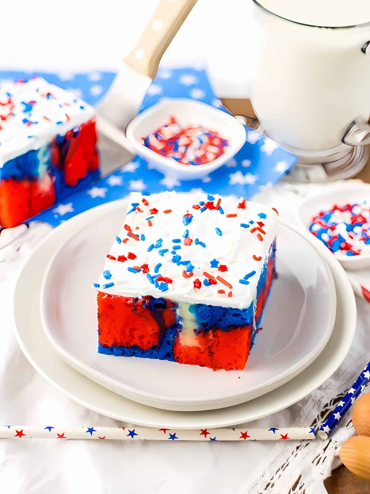 4th of July themed poke cake topped with sprinkles.