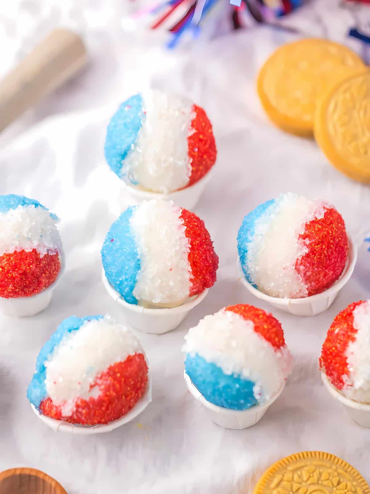 Red white and blue colored snow cone Oreo truffles in a small cup.
