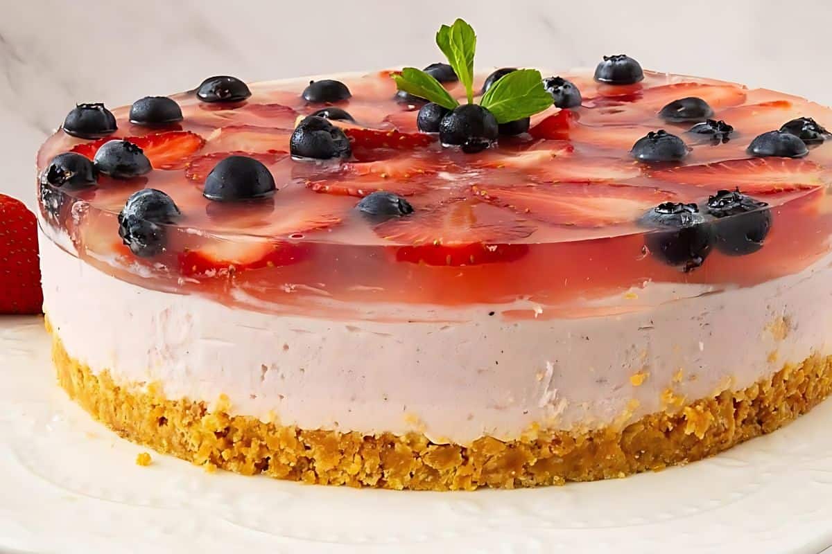 Strawberry mousse cake with blueberries on top.