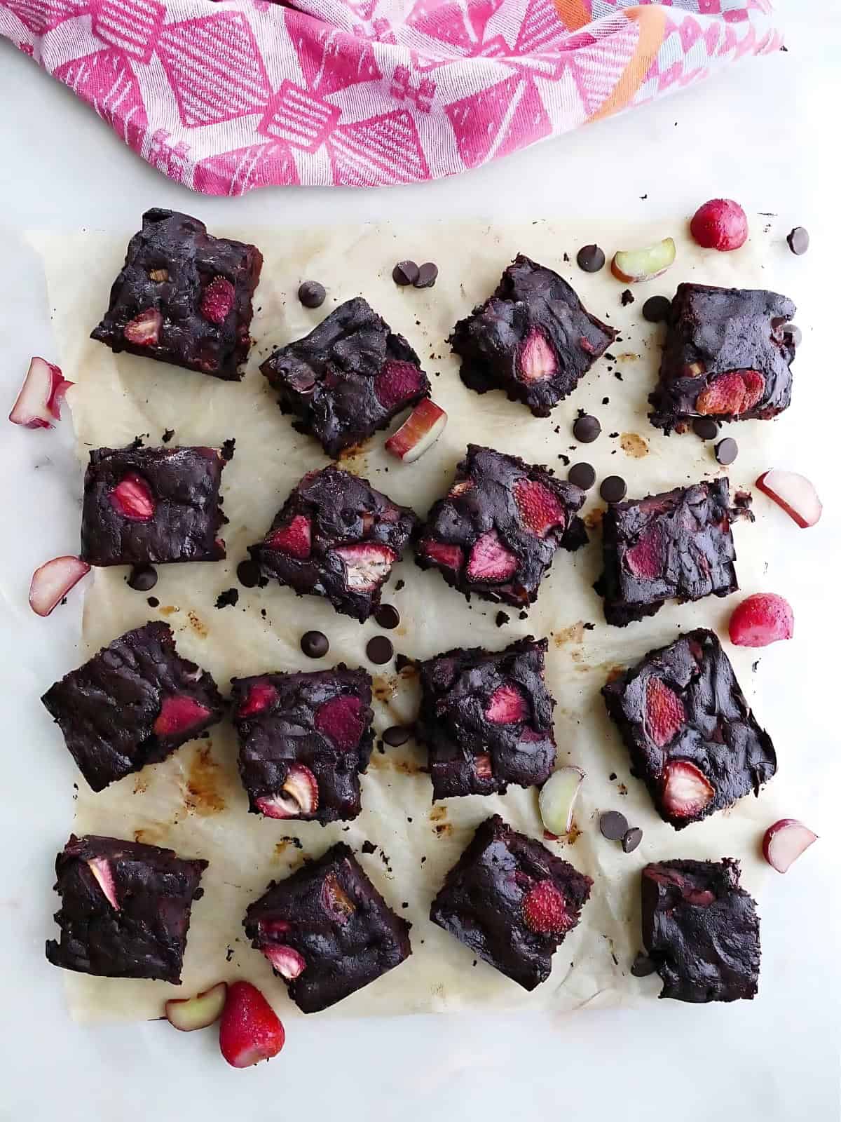 Double chocolate rhubarb brownies on a baking paper.