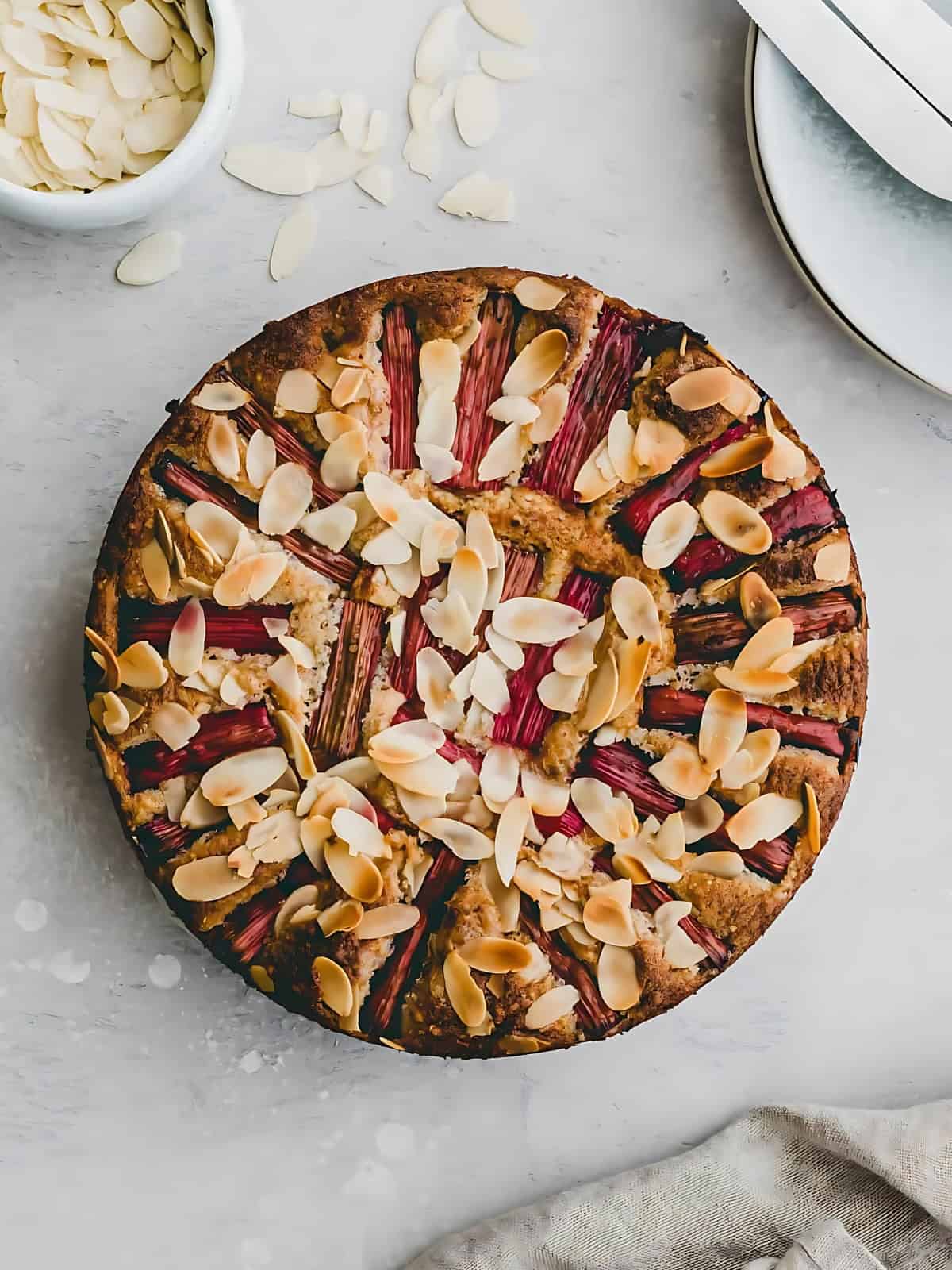 Rhubarb almond cake topped with almonds.