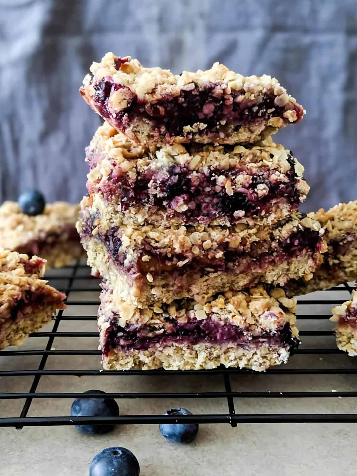 Stacked rhubarb blueberry crumble bars.