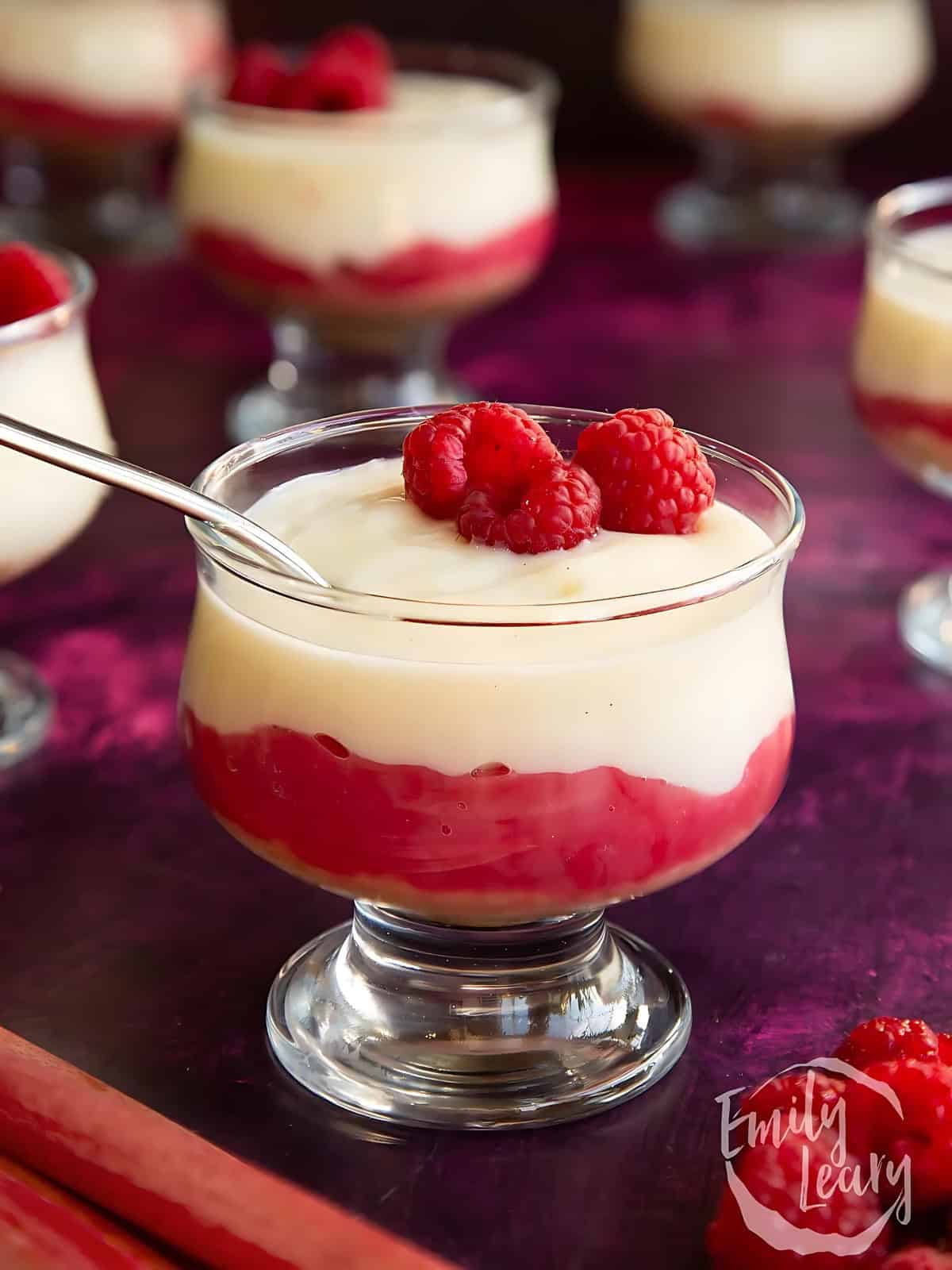 Rhubarb custard pudding topped with raspberries.