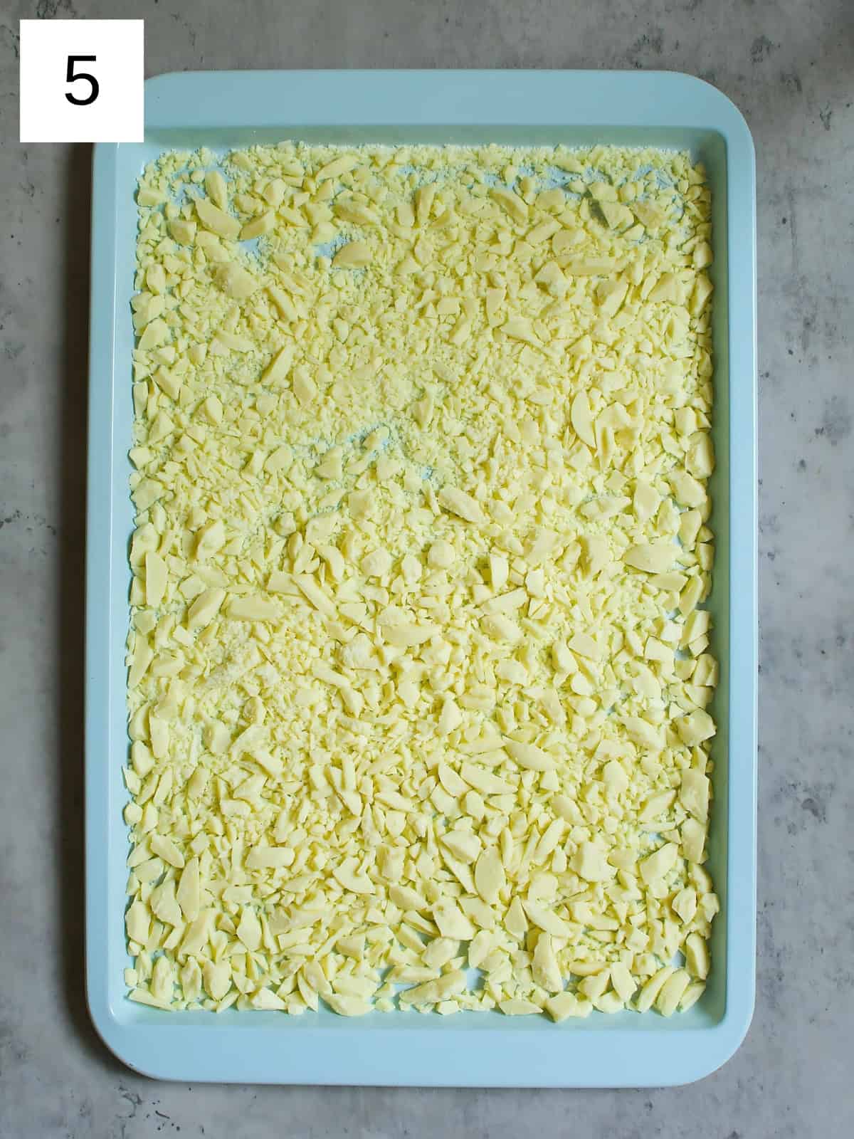 Diced white chocolates on a baking tray.