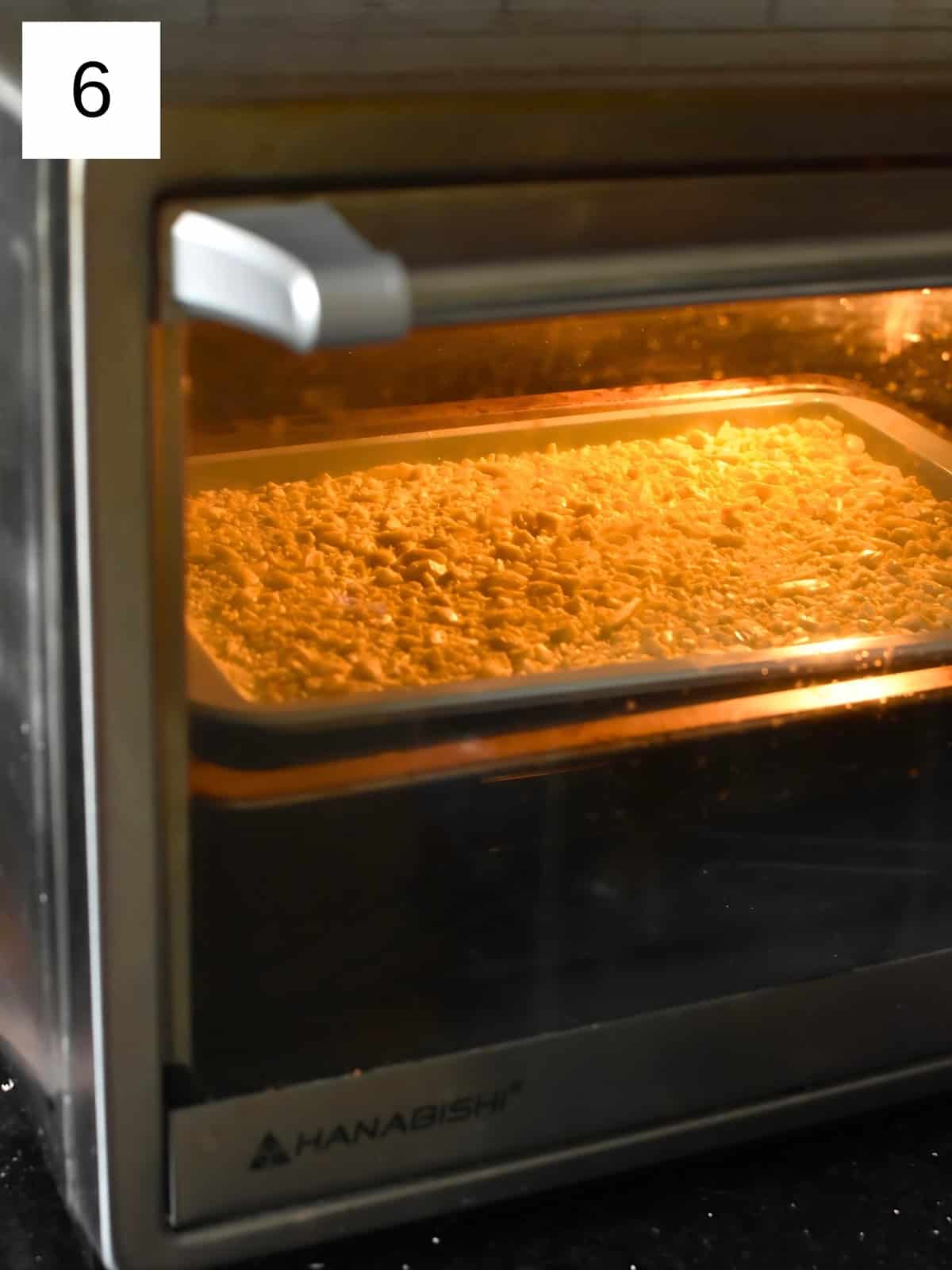 Diced white chocolates being baked in an oven.