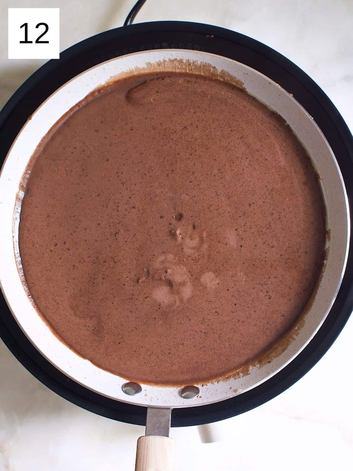 Chocolate crepe batter in a heated pan.