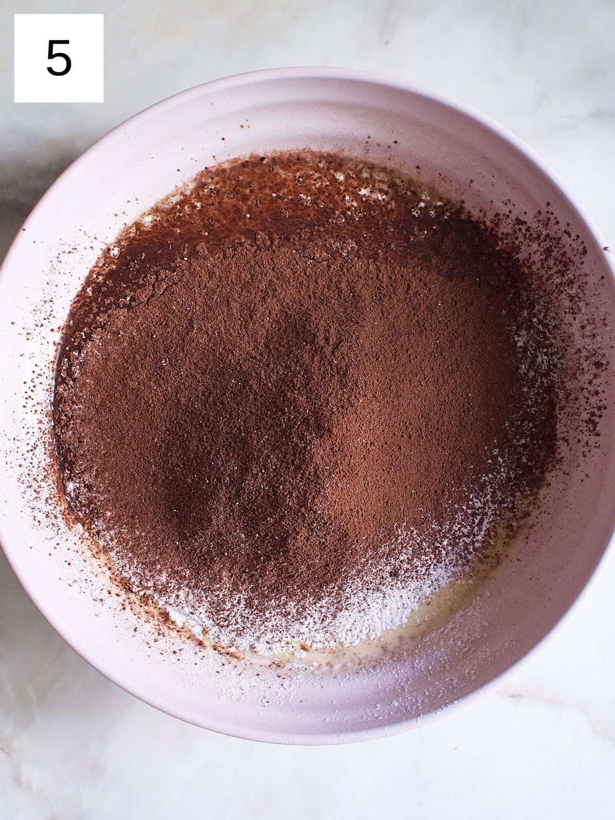 A bowl of crepe batter mixed with cocoa powder and flour.