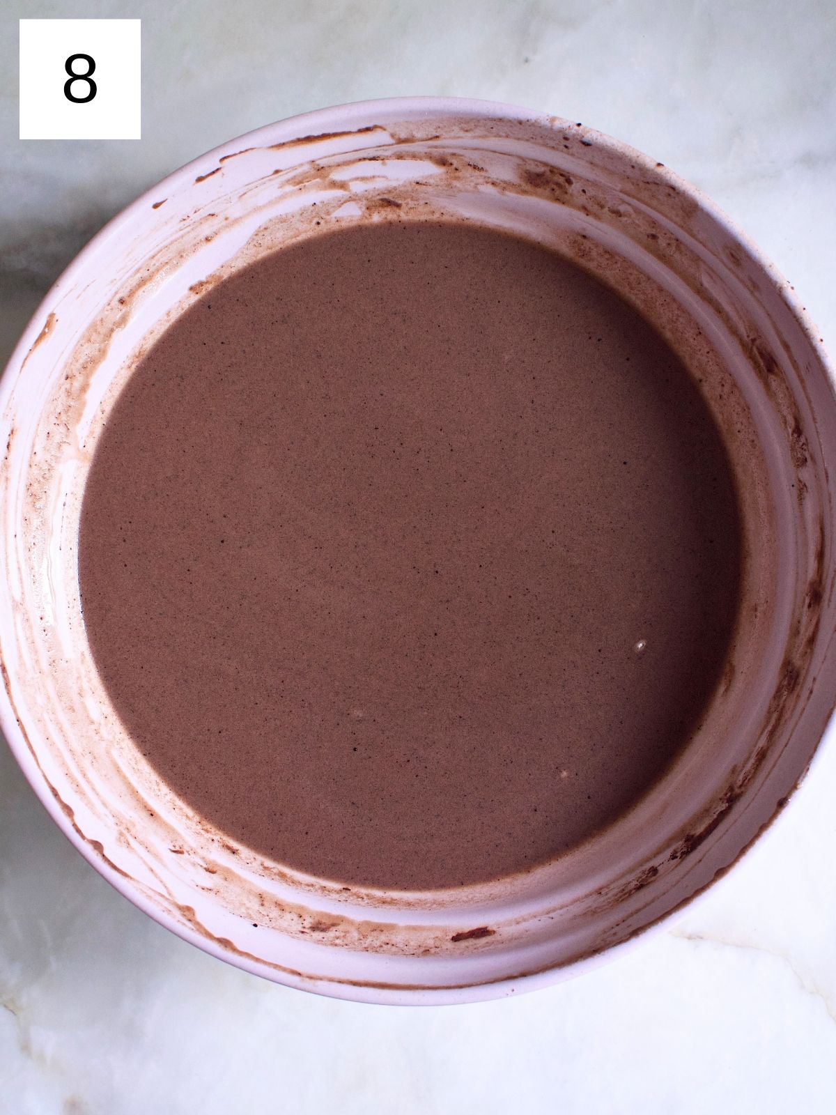 Whisked bowl of chocolate crepe batter.