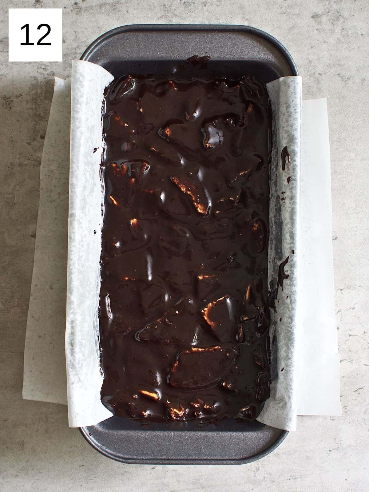 Chocolate lazy cake mixture with biscuits ready to be frozen.