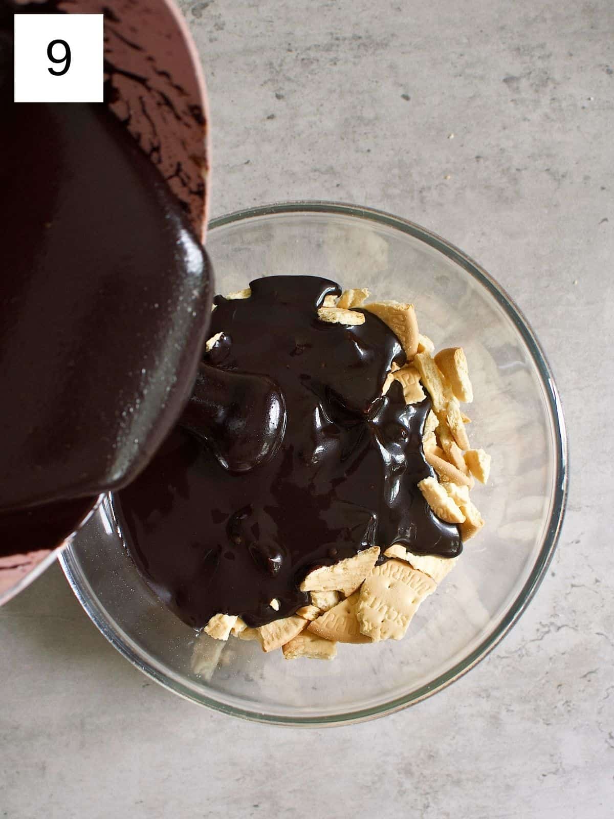 Pouring chocolate mixture over a bowl of biscuits.