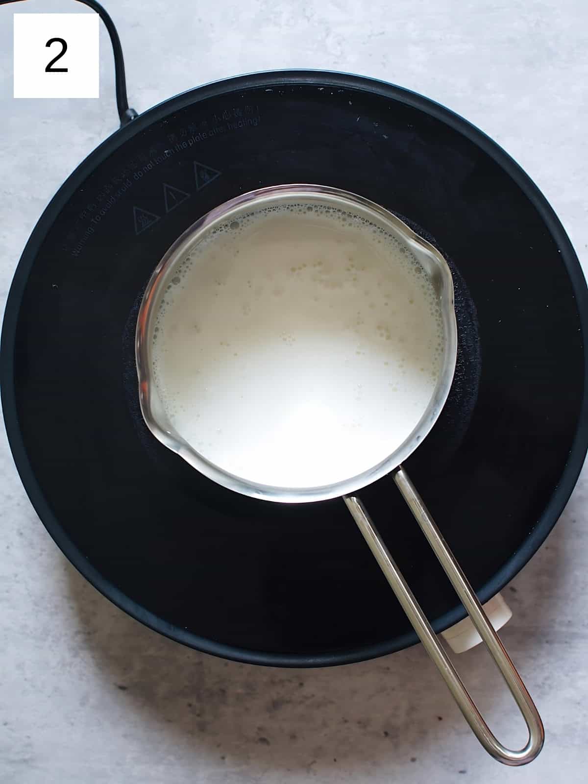Milk being heated in a pan.