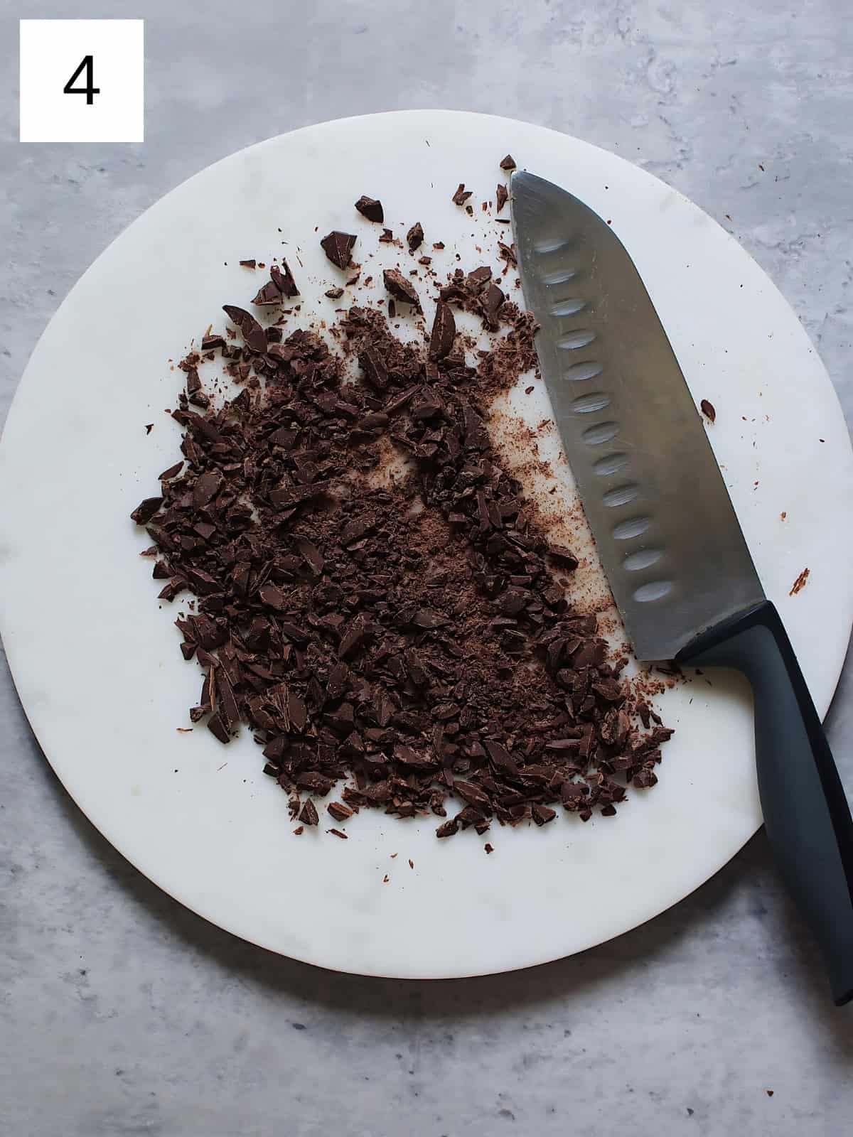 Minced chocolates on a plate next to a knife.