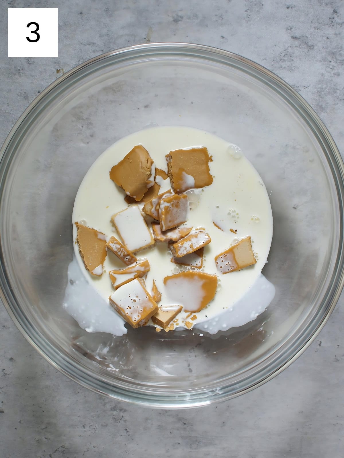 A bowl of blonde chocolates with heavy cream.