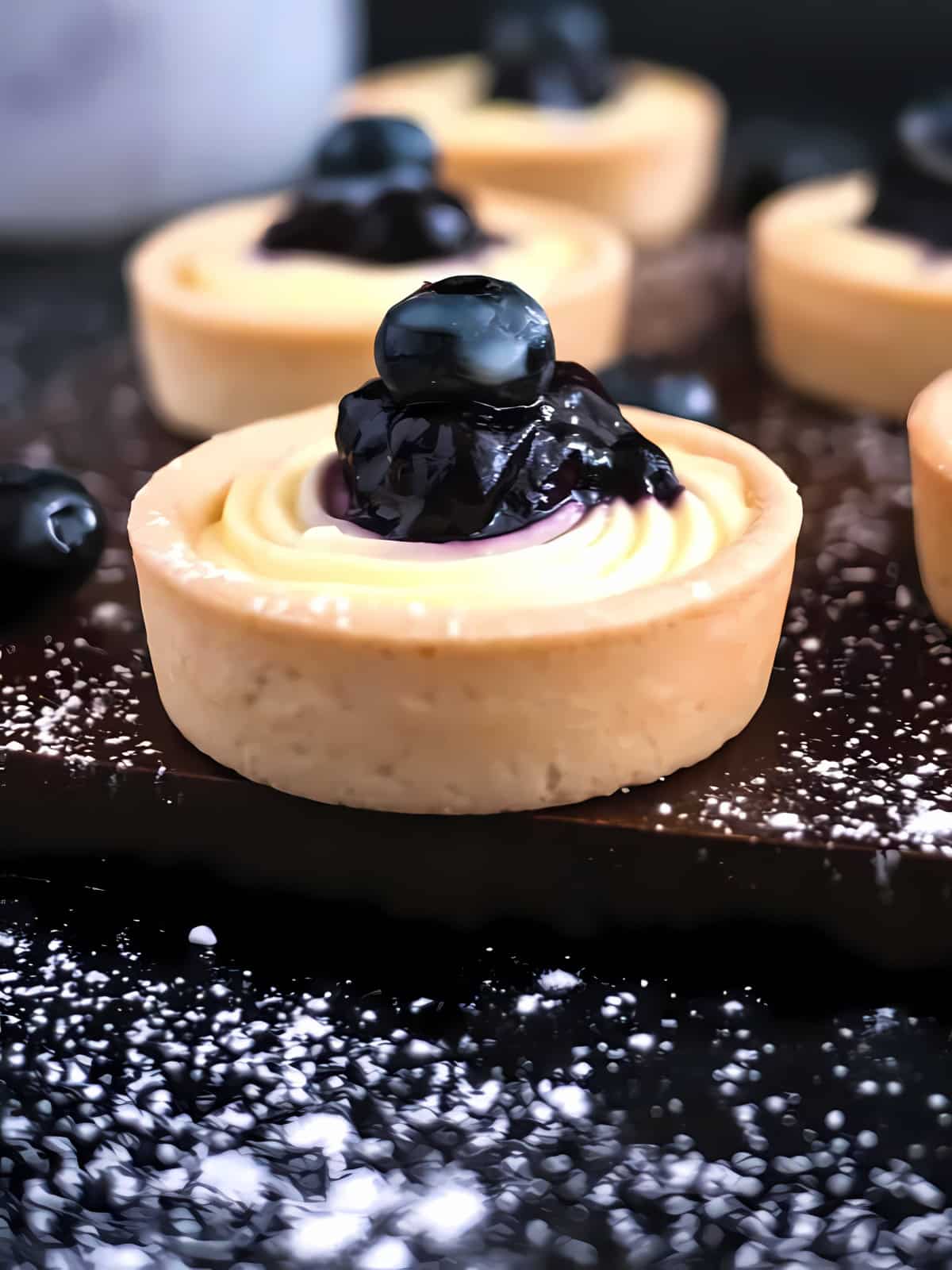 Blueberry cream cheese tartlets topped with blueberry.