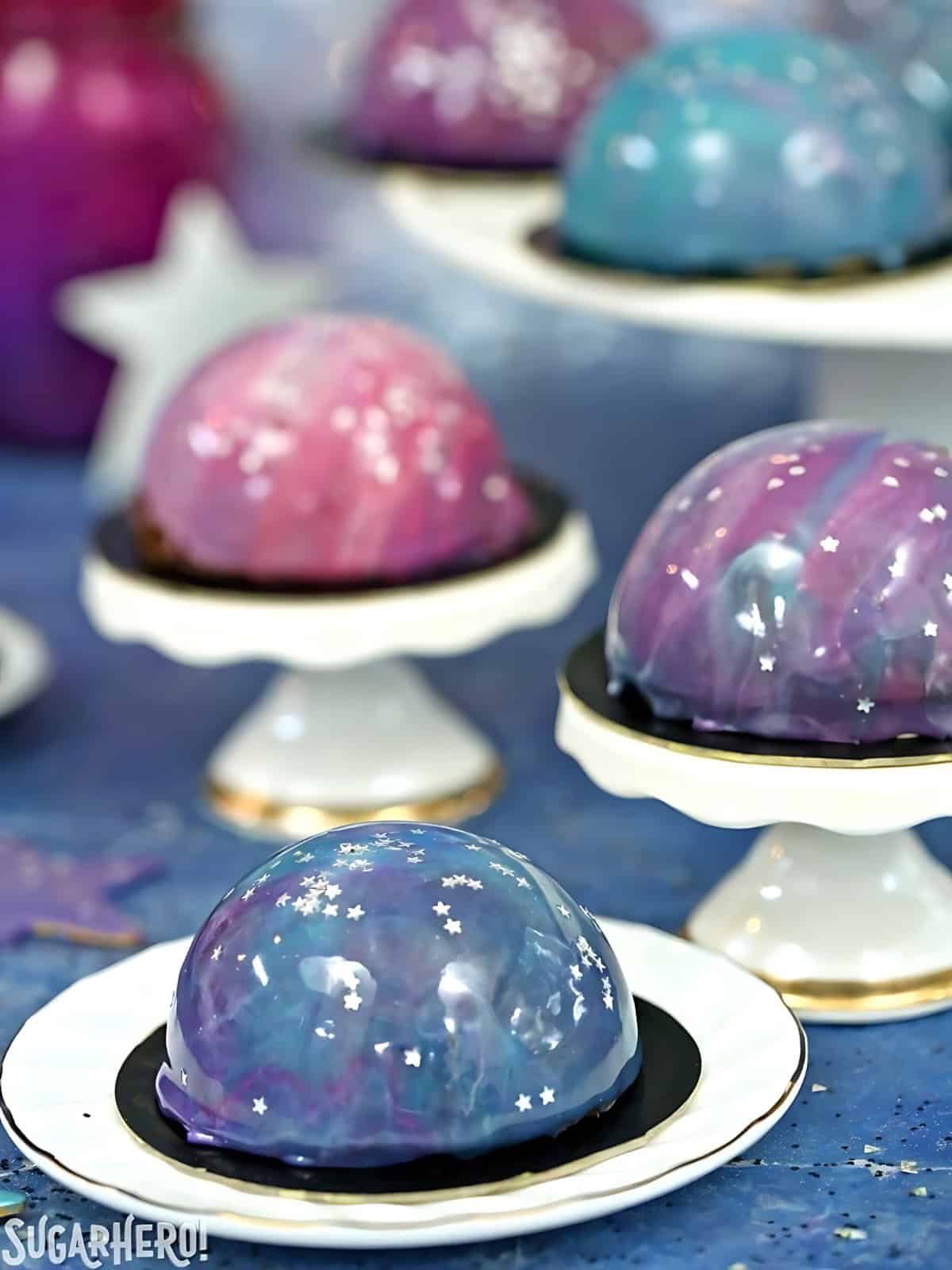 Galaxy themed mousse cakes being displayed.