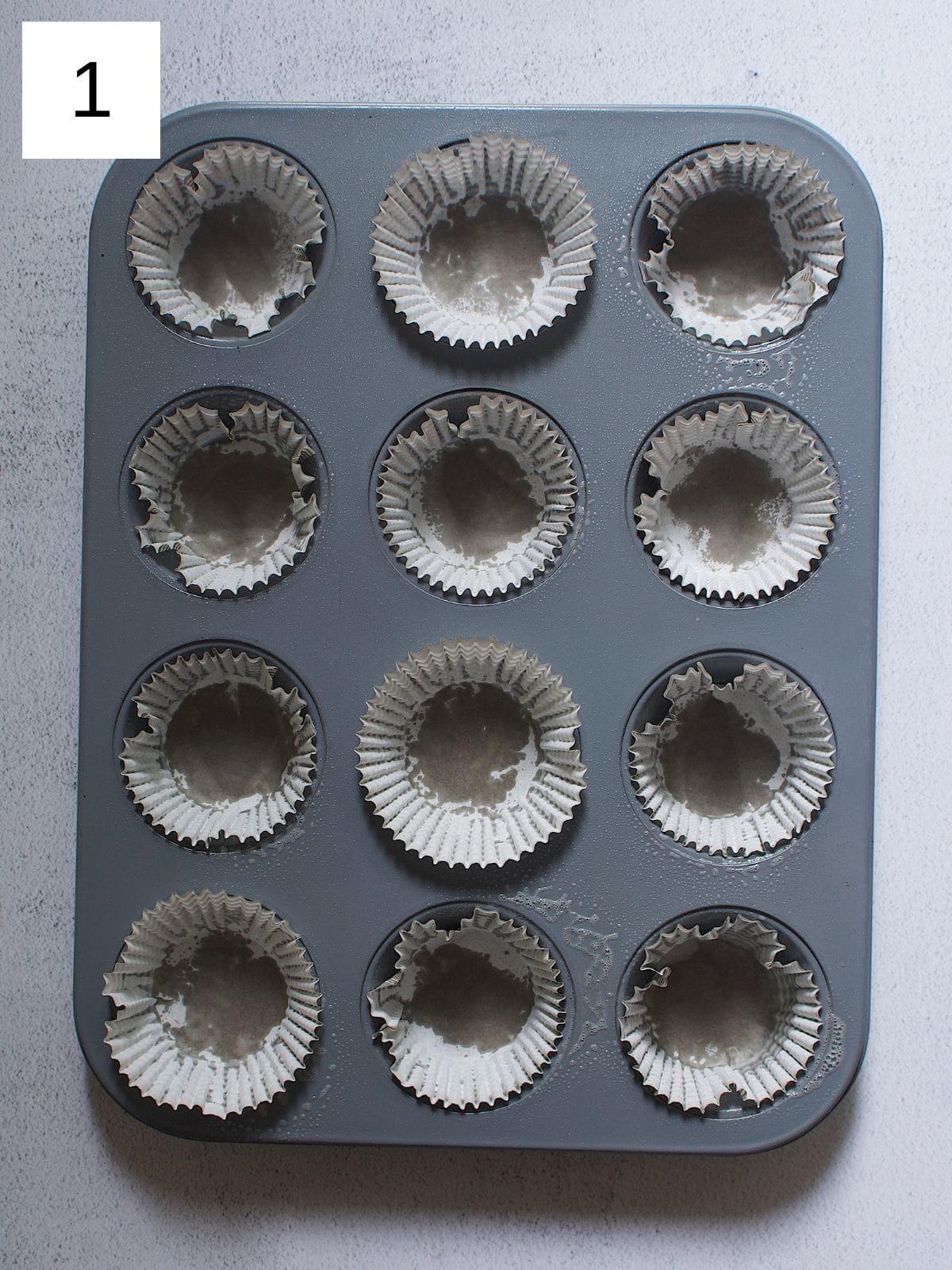 Cupcake liners placed in a muffin tray.