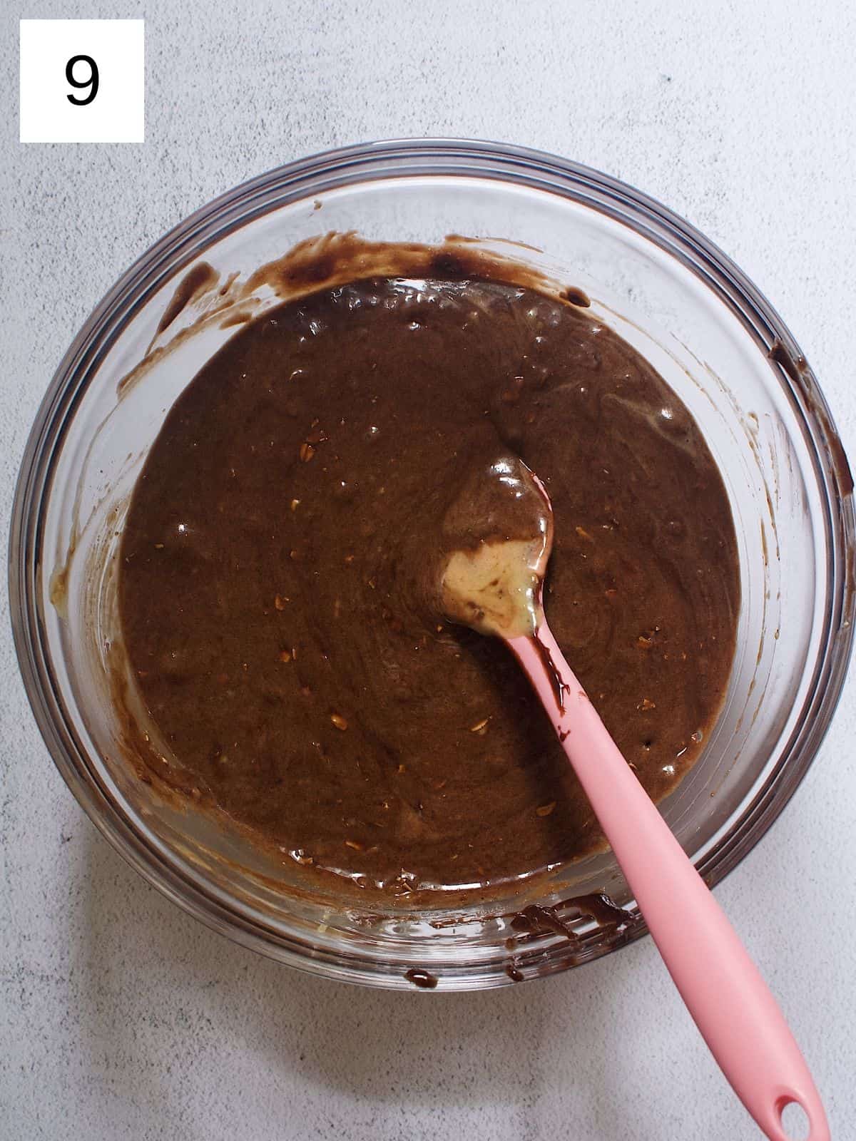 A bowl of banana chocolate protein batter mixed with apple cider vinegar.