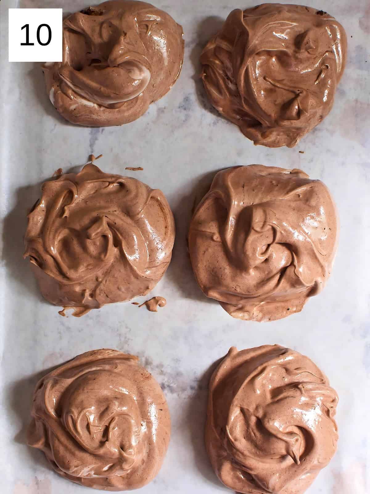 Dollops of meringue placed on a baking sheet.