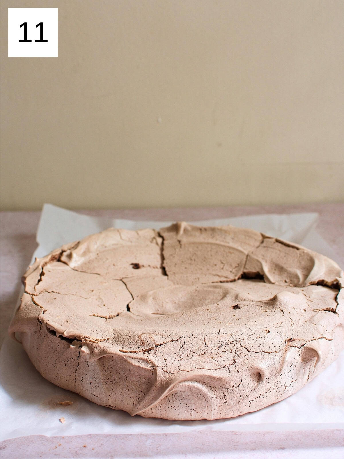 Cooled circular-shaped meringue on a baking tray with parchment paper.