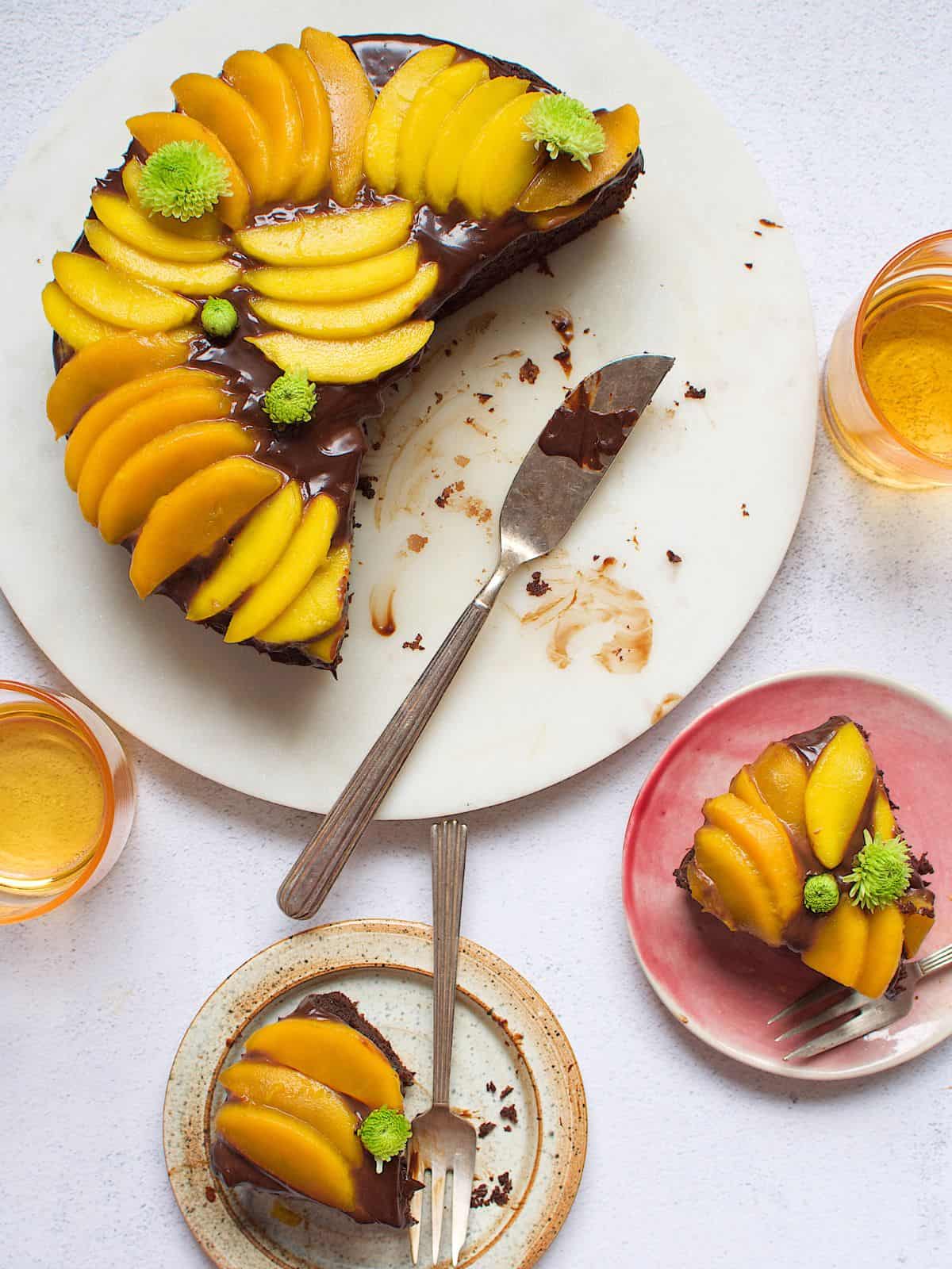 Chocolate mango cake next to slices of chocolate mango cake.