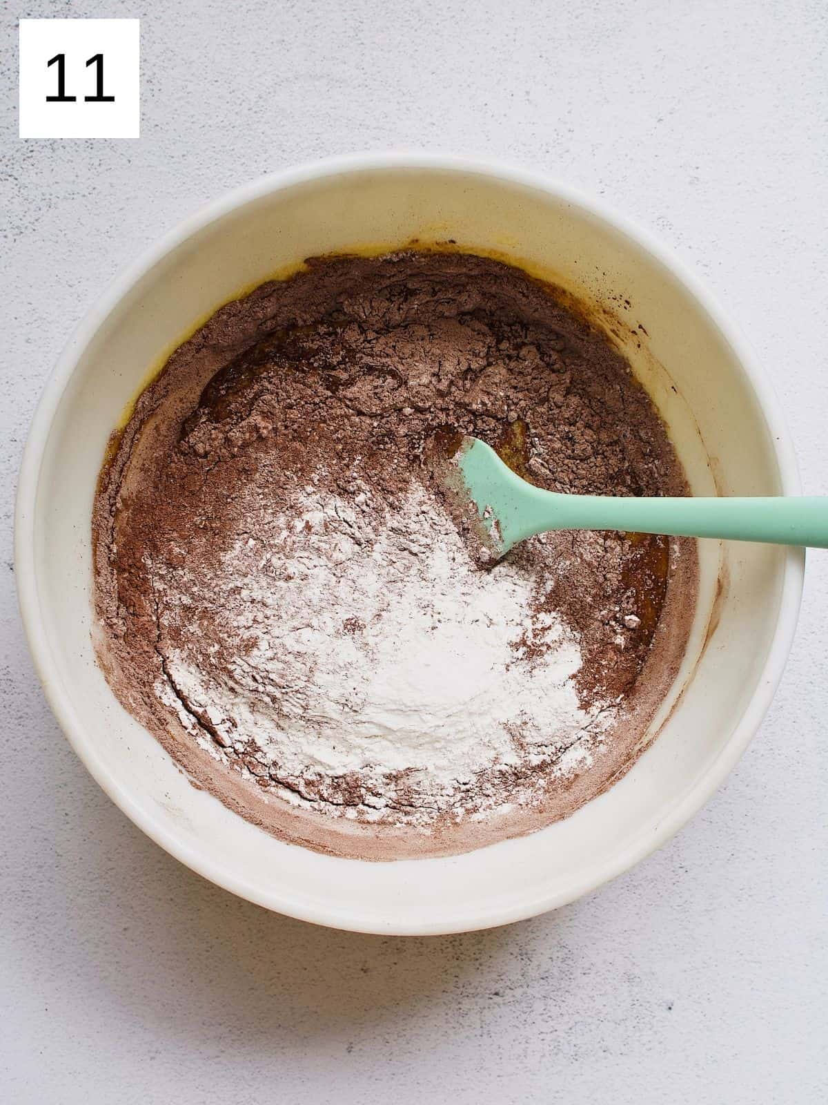 Chocolate mango cake dry and wet ingredients in a bowl.