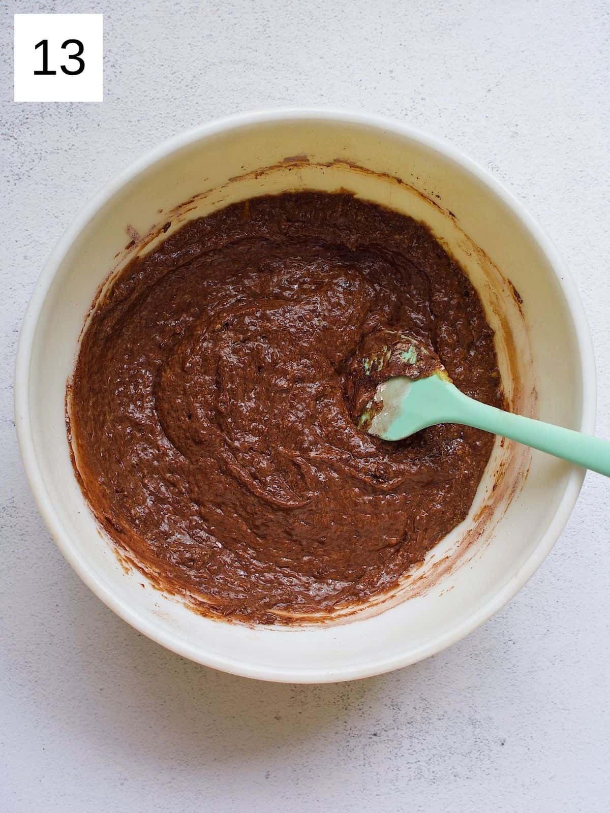 Fully mixed chocolate mango cake dry and wet ingredients in a bowl.